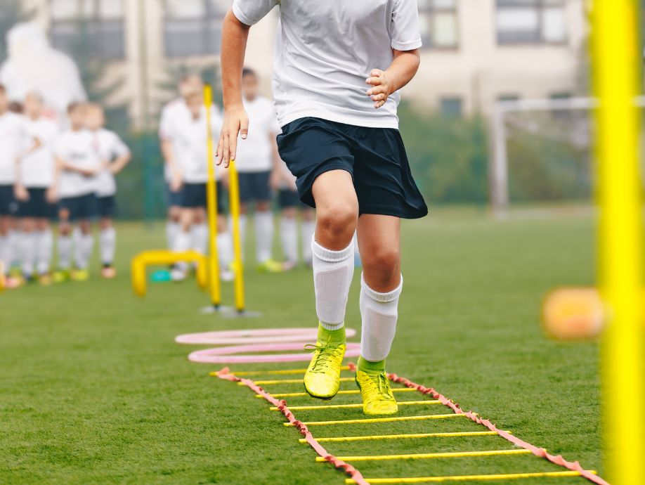 soccre-agility-ladder a soccer player training on agility ladder