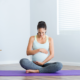 A women sitting in a prenatal yoga center